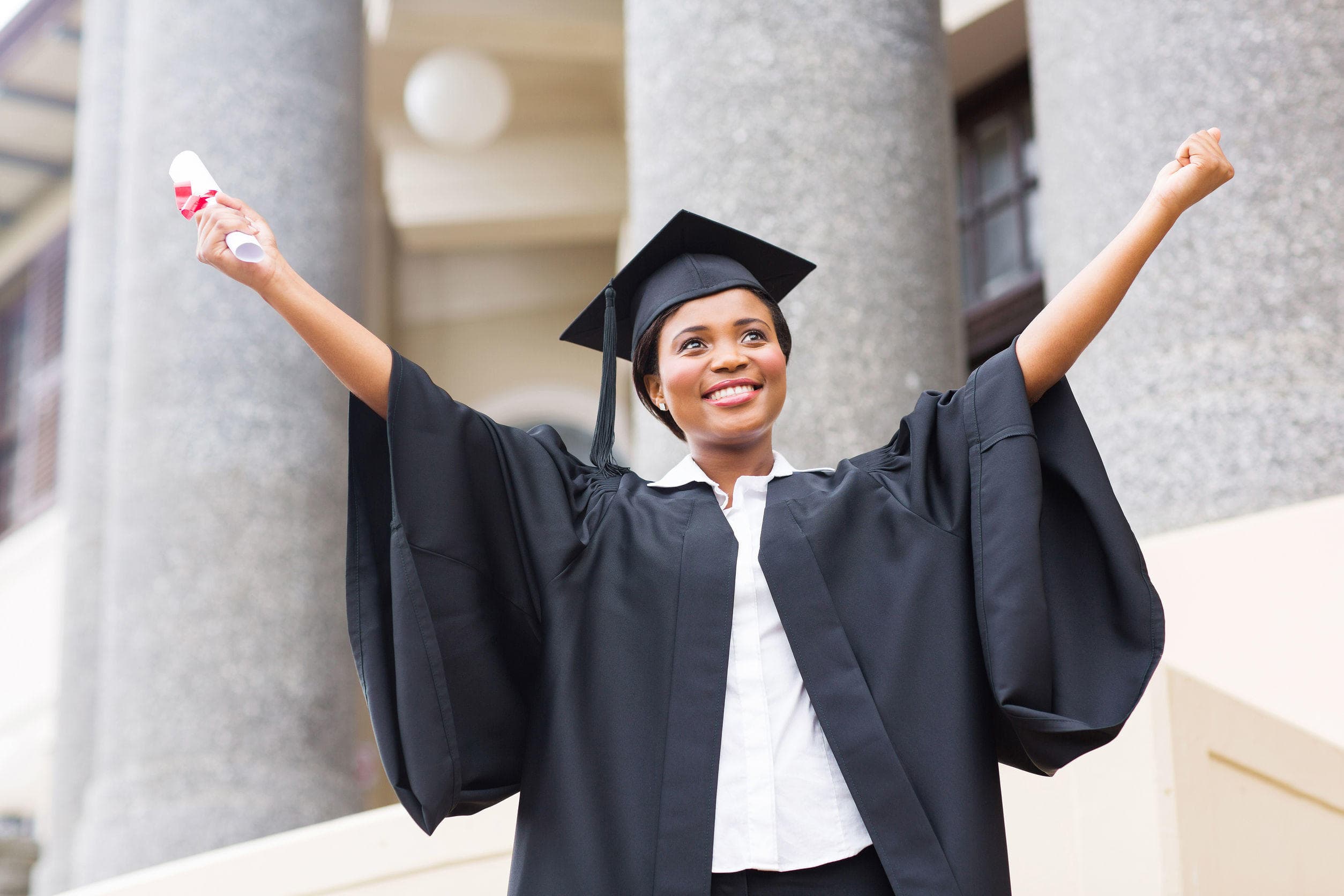 A young lady in a gown graduating